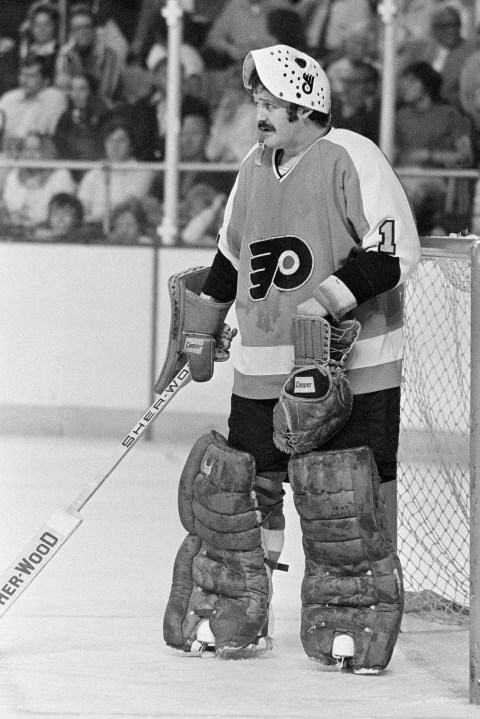 FILE - Philadelphia Flyers goalie Bernie Parent raises his mask to take a break during the Stanley Cup finals in Buffalo, N.Y., May 28, 1975, against the Buffalo Sabres. (AP Photo, File)