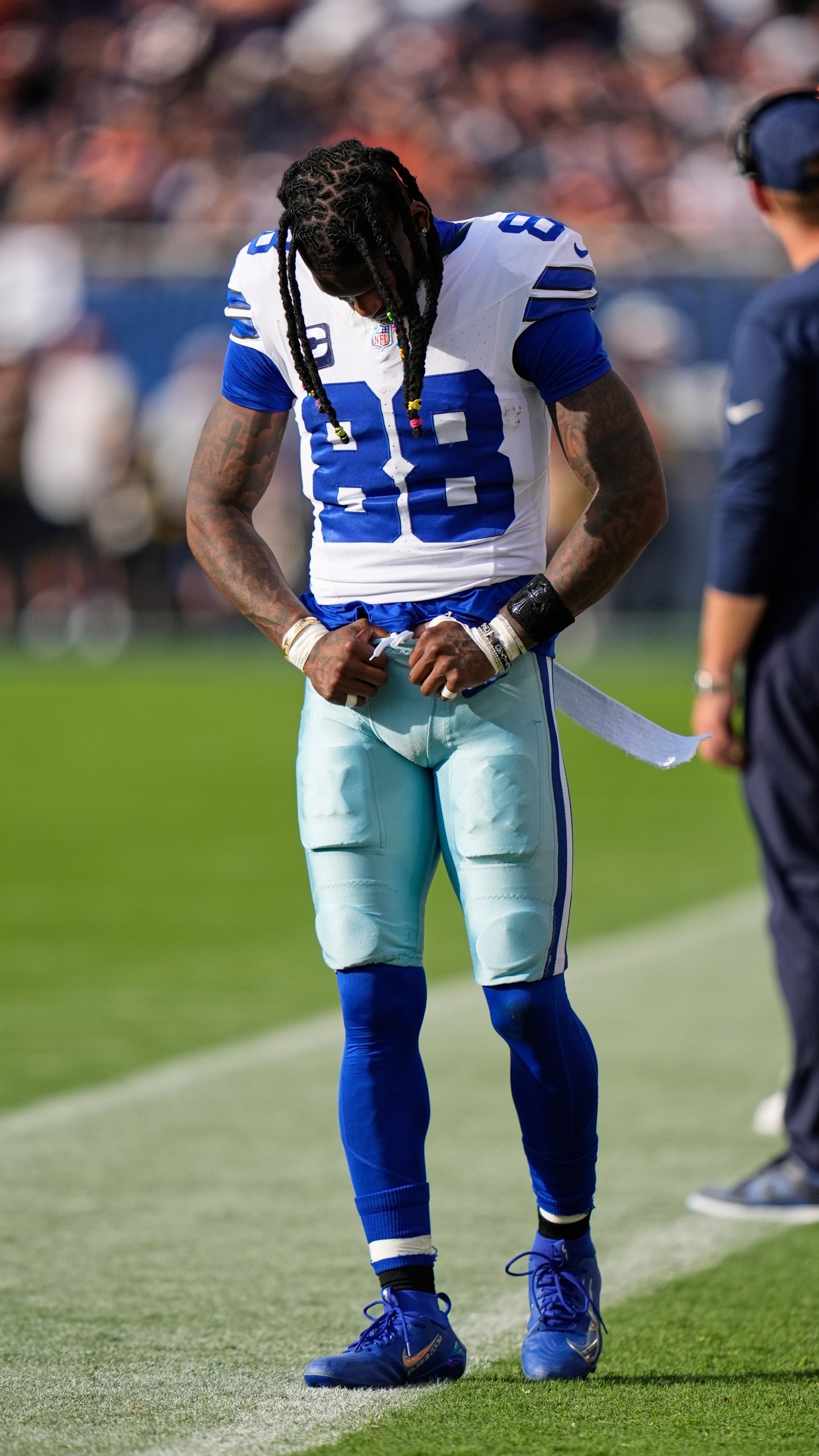Dallas Cowboys wide receiver CeeDee Lamb walks along the sideline after suffering an unknown injury in the first half of an NFL football game against the Chicago Bears Sunday, Sept. 21, 2025, in Chicago. (AP Photo/Erin Hooley)