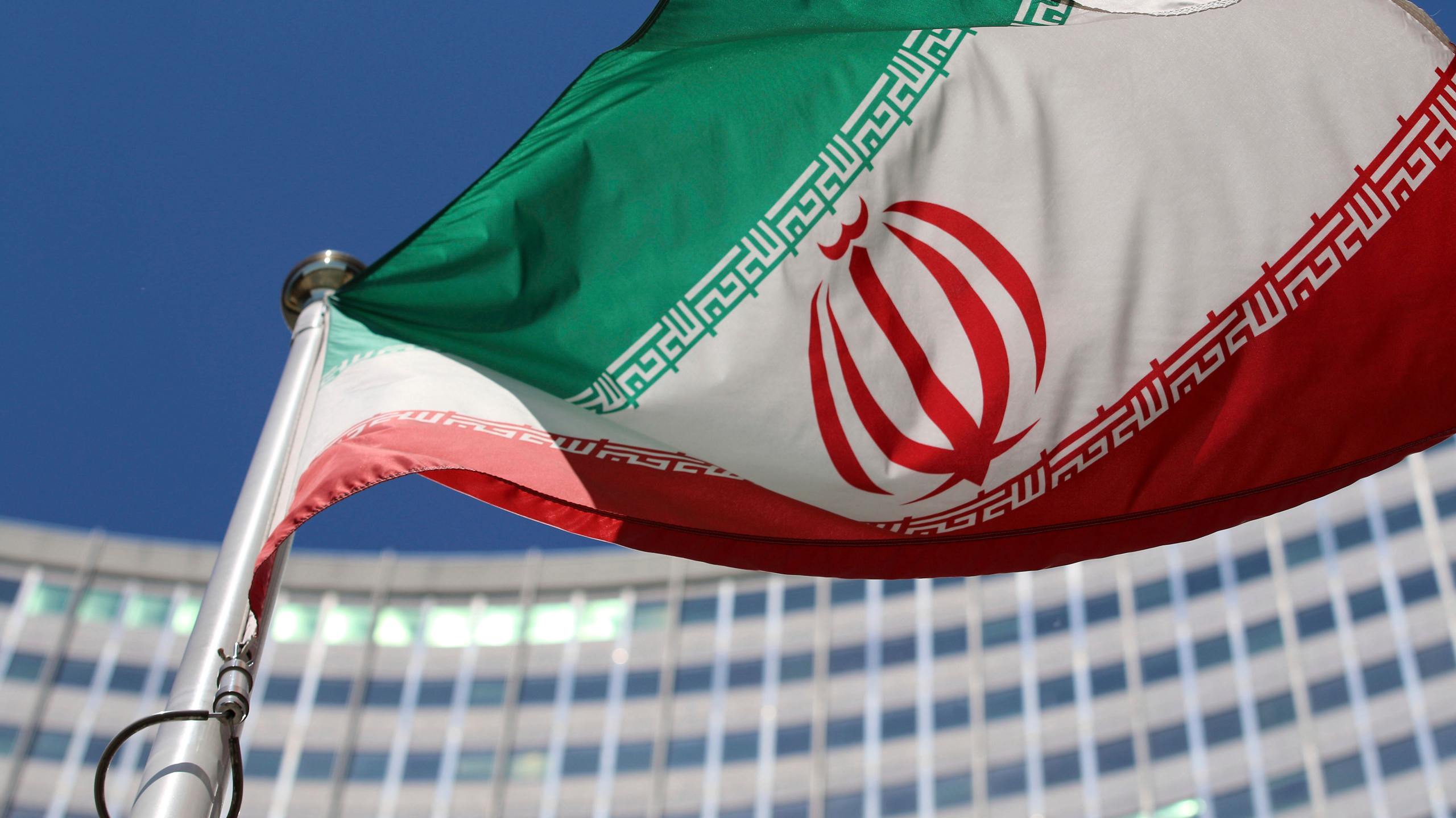 FILE - The Iranian flag flies in front of a U.N. building where closed-door nuclear talks take place at the International Center in Vienna, Austria, on June 18, 2014. (AP Photo/Ronald Zak, File)