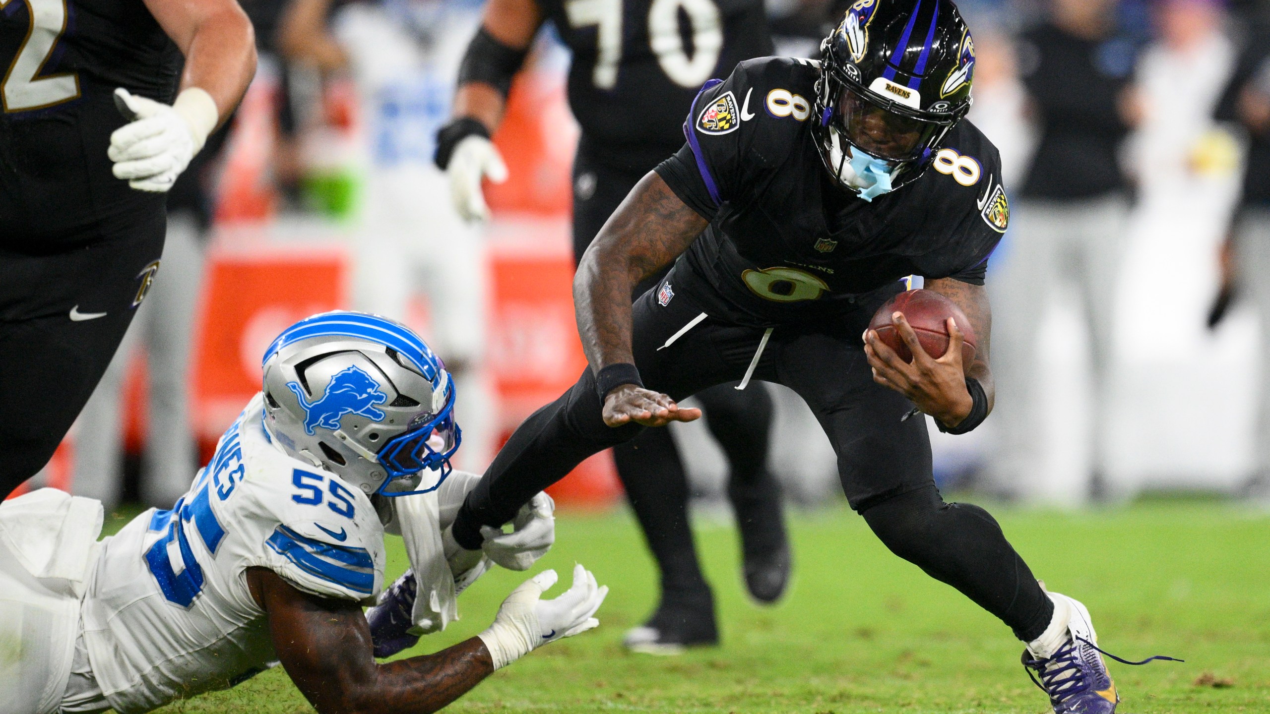 Baltimore Ravens quarterback Lamar Jackson (8) is tripped up by Detroit Lions linebacker Derrick Barnes (55) during the second half of an NFL football game Monday, Sept. 22, 2025, in Baltimore. (AP Photo/Nick Wass)