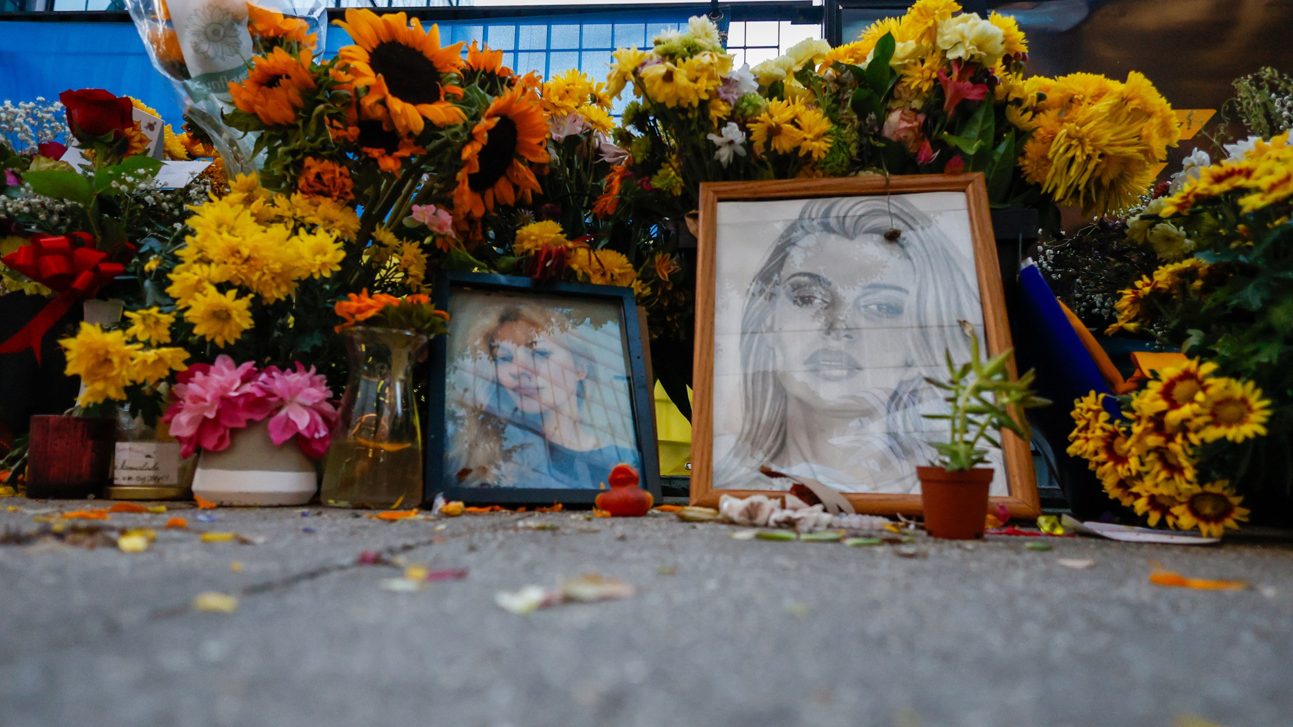 Flowers and photos are left near the tracks where Iryna Zarutska, who was fatally stabbed on a commuter train last month, Monday, Sept. 22, 2025, in Charlotte, N.C. (AP Photo/Nell Redmond)