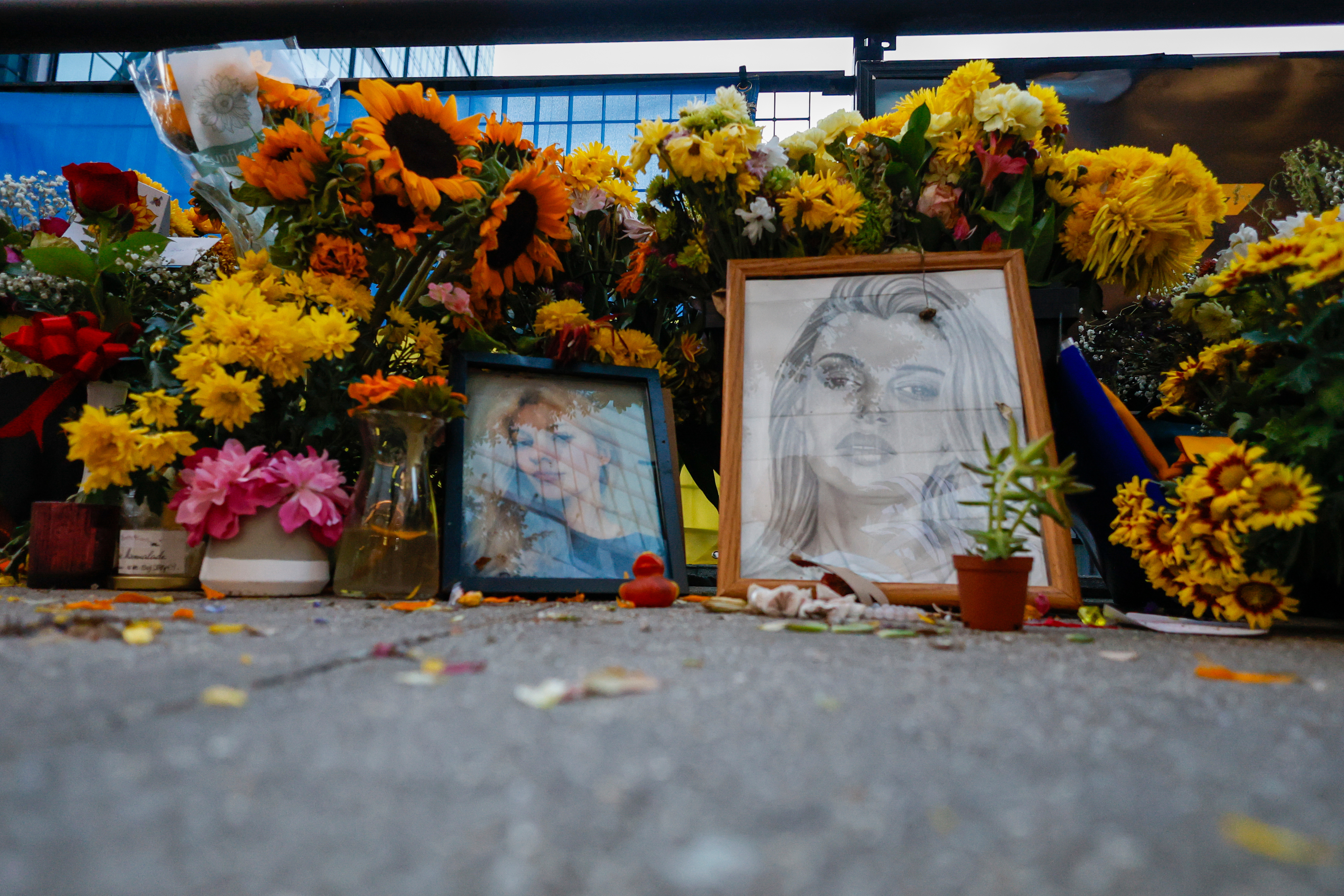 Flowers and photos are left near the tracks where Iryna Zarutska, who was fatally stabbed on a commuter train last month, Monday, Sept. 22, 2025, in Charlotte, N.C. (AP Photo/Nell Redmond)
