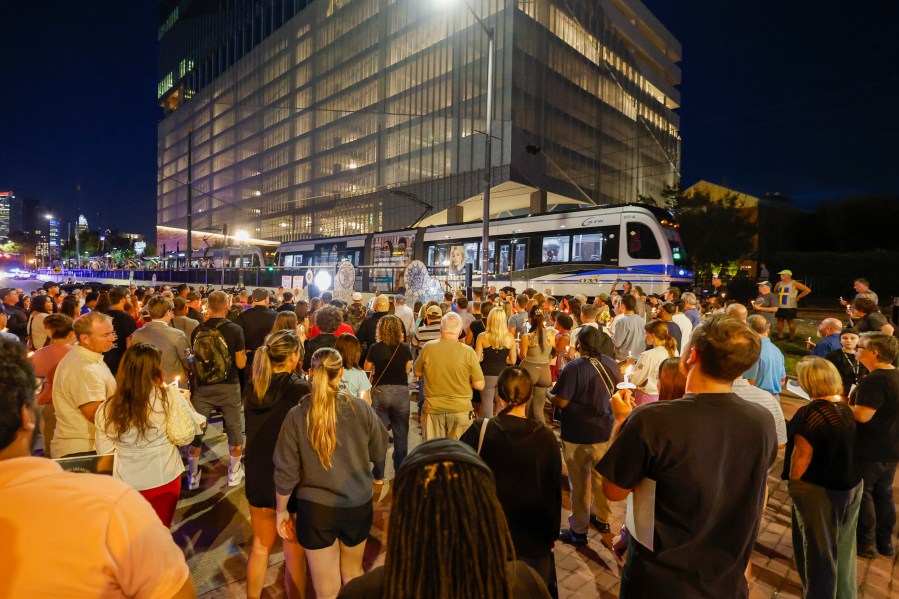 A light rail train passes by as community members gather for a vigil honoring the life of Iryna Zarutska, who was fatally stabbed on a commuter train last month, Monday, Sept. 22, 2025, in Charlotte, N.C. (AP Photo/Nell Redmond)