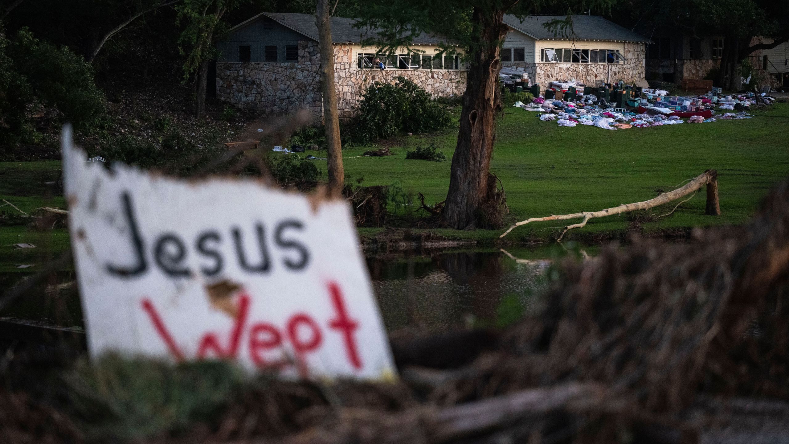 FILE - Campers belongings sit outside one of Camp Mystic's cabins near the Guadalupe River, July 7, 2025, in Hunt, Texas, after a flash flood swept through the area. (AP Photo/Eli Hartman, File)