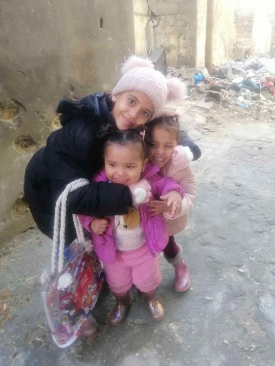 In this undated photo taken during the Israel-Hamas war, Noor Abu Hassira's three daughters, Jouri, Maria and Maha, smile and pose in Gaza City, Gaza Strip. (Noor Abu Hassira via AP)