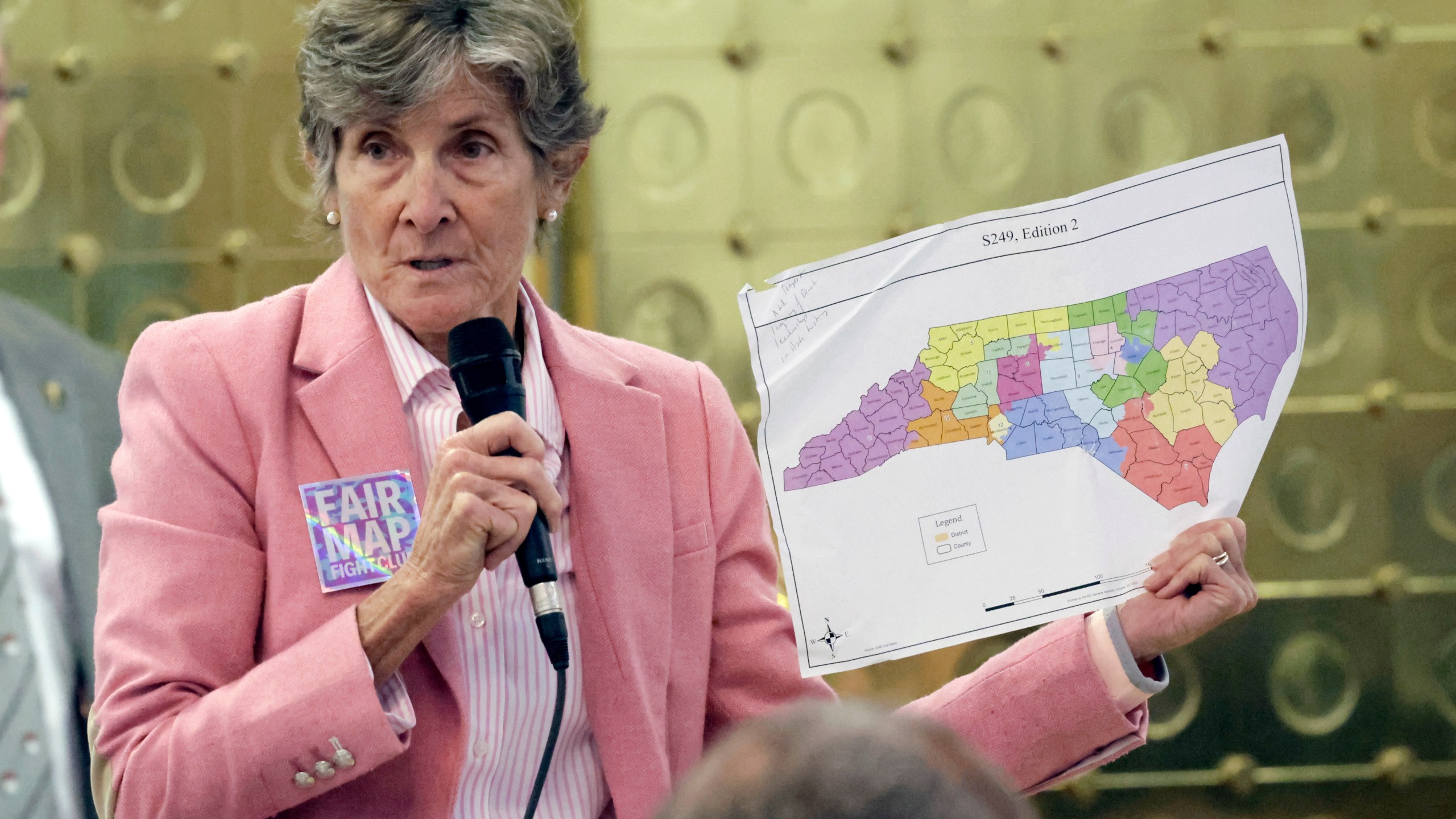 Rep. Pricey Harreison, D-Guilford, holds an alternative map as she speaks on a redistricting bill at the Legislative Building, Wednesday, Oct. 22, 2025, in Raleigh, N.C. (AP Photo/Chris Seward)