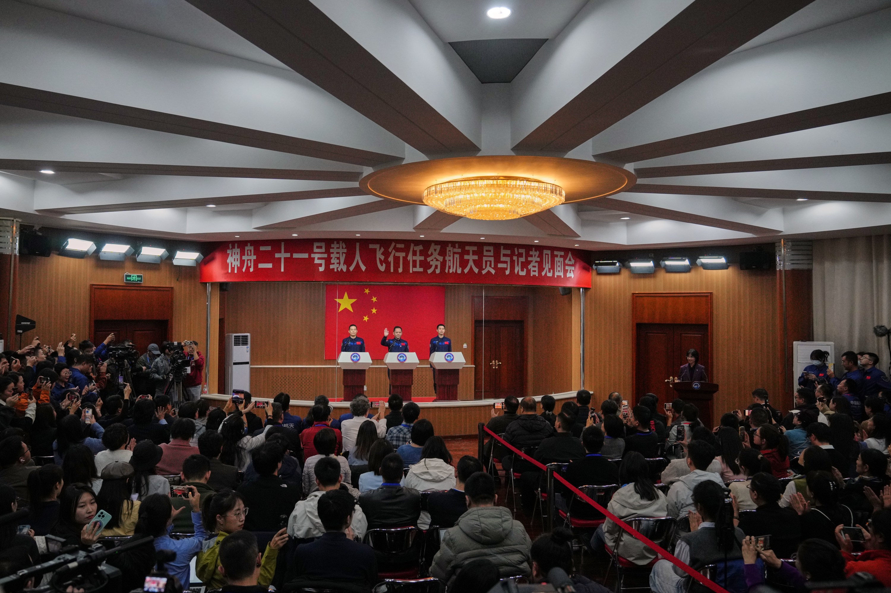 Astronauts for the upcoming Shenzhou 21 mission, from left, Zhang Hongzhang, Zhang Lu and Wu Fei arrive for a meeting with the press at the Jiuquan Satellite Launch Center in Jiuquan, northwest China, Thursday, Oct. 30, 2025. (AP Photo/Andy Wong)