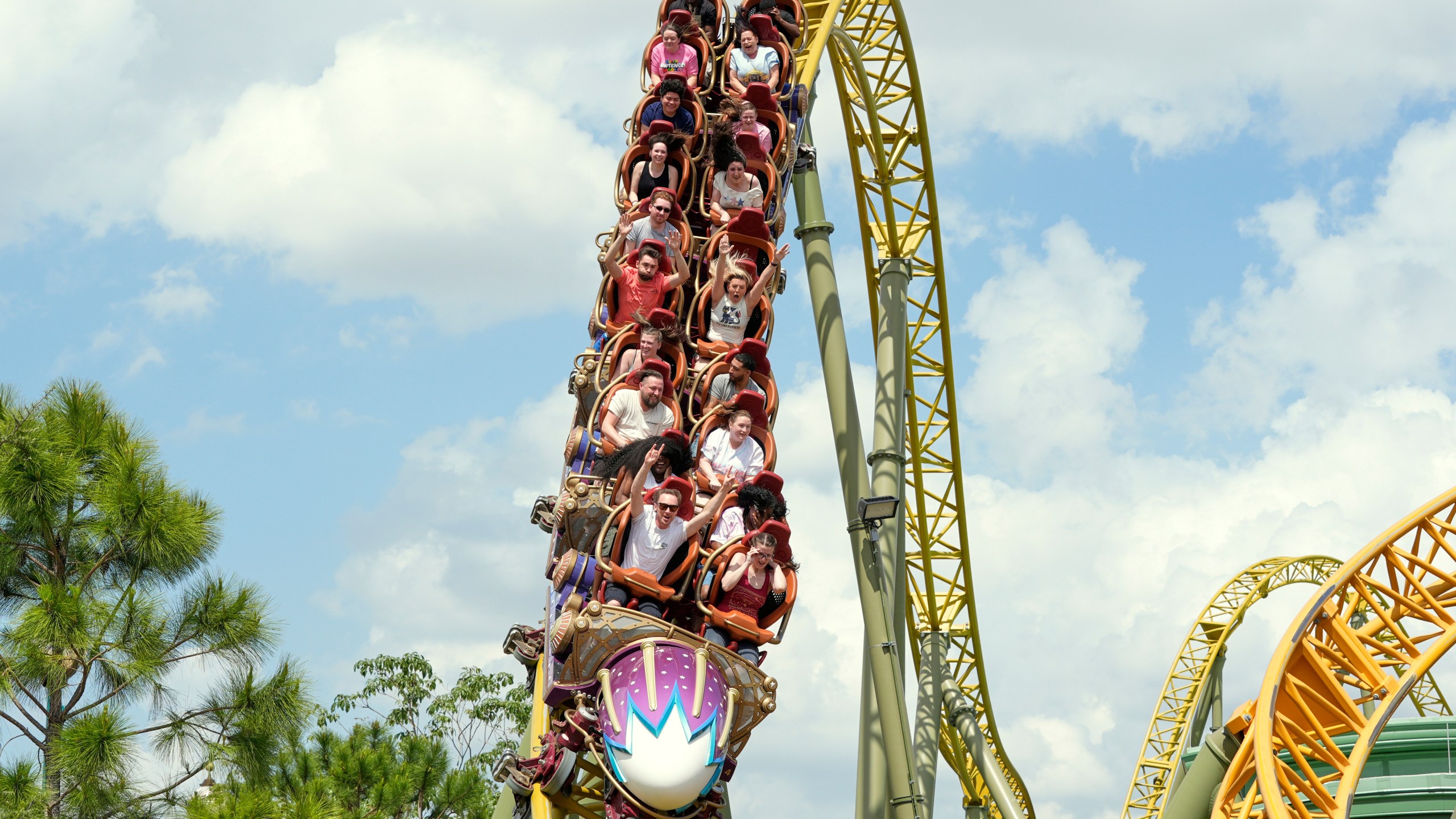 FILE - Guests ride on the Stardust Racers roller coaster at Epic Universe Theme Park at Universal Resort Orlando, April 10, 2025, in Orlando, Fla. (AP Photo/John Raoux, file)