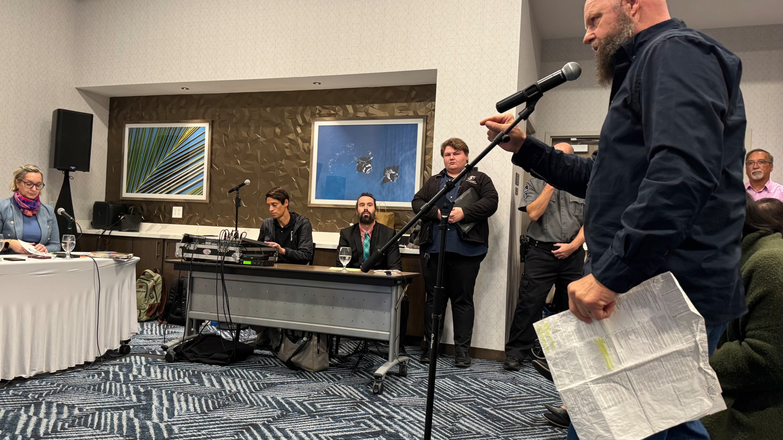 Larry Downs of Pensacola, Fla., testifies against childhood vaccine mandates at a public hearing held by Florida’s Department of Health on Friday, Dec. 12, 2025 in Panama City Beach, Fla. (AP Photo/Kate Payne)