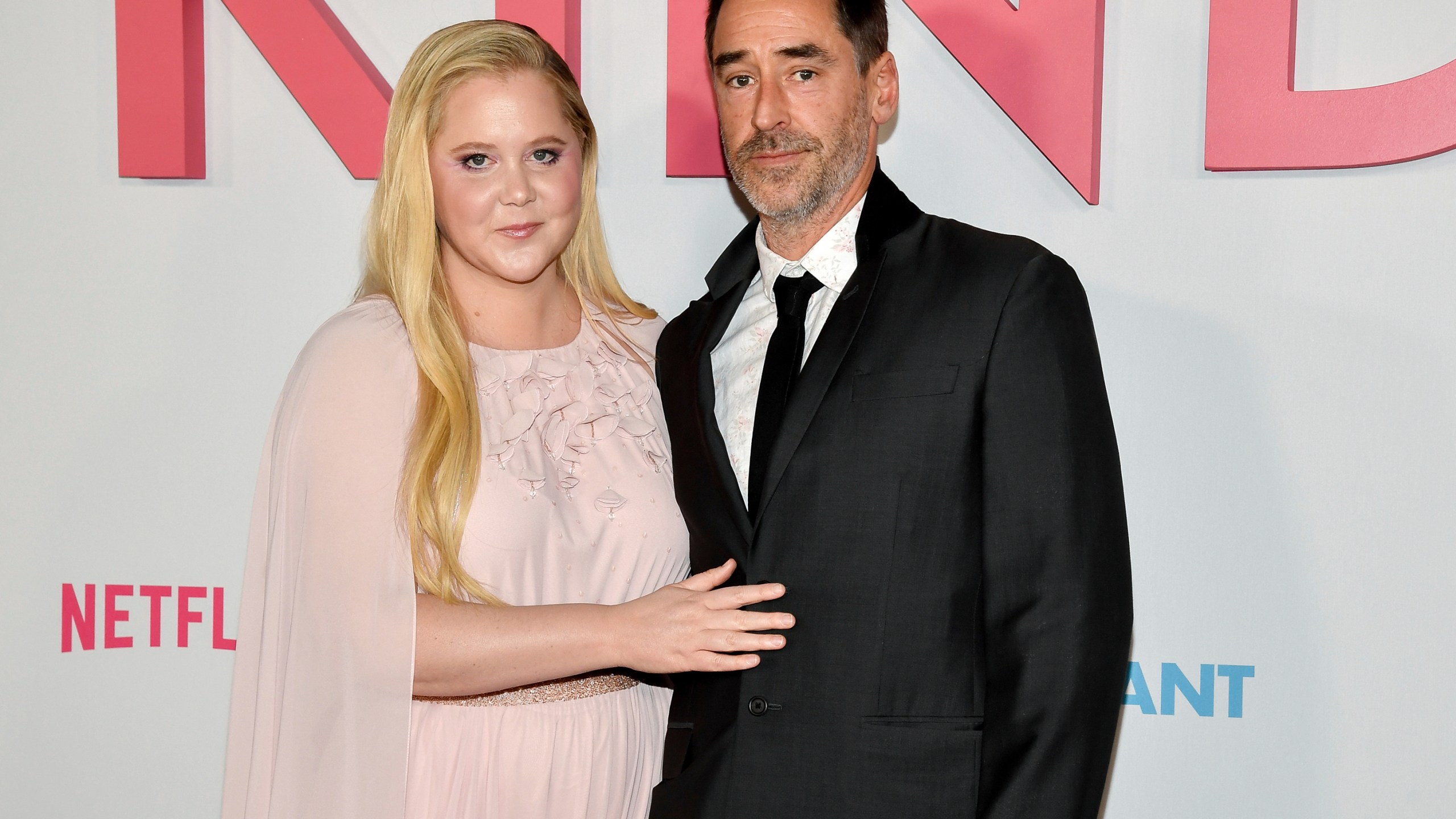 FILE - Amy Schumer and husband Chris Fischer attend the premiere of Netflix's "Kinda Pregnant" at The Plaza Hotel in New York, Feb. 3, 2025. (Photo by Evan Agostini/Invision/AP File)