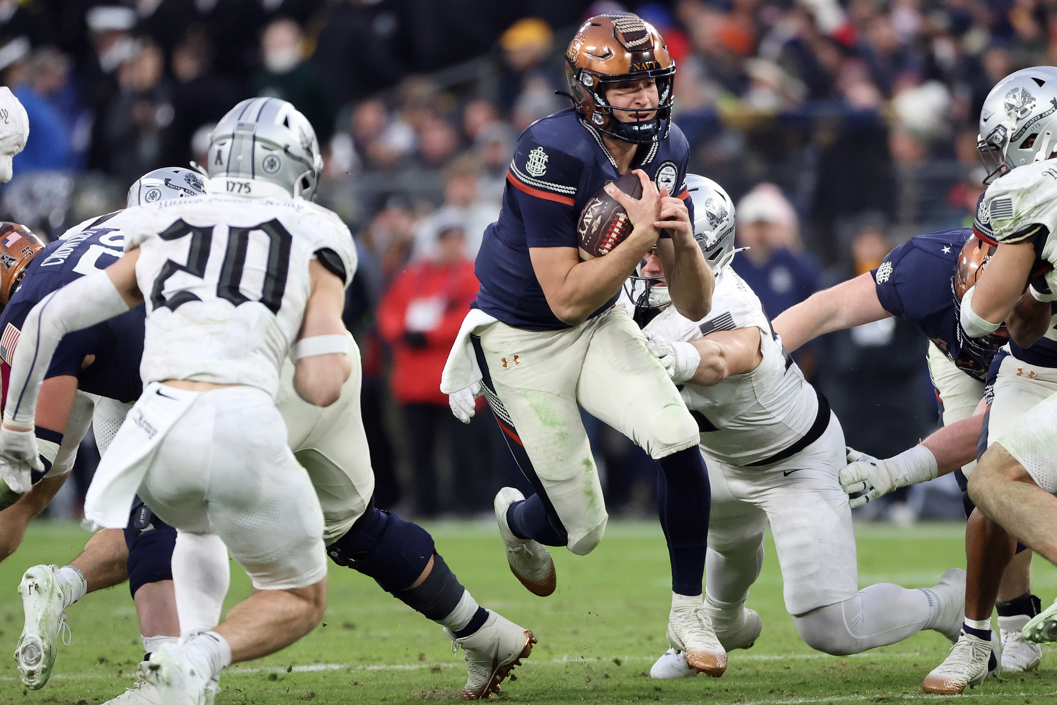 Navy quarterback Blake Horvath runs with the ball during the first half of an NCAA college football game against Army, Saturday, Dec. 13, 2025, in Baltimore. (AP Photo/Daniel Kucin Jr.)