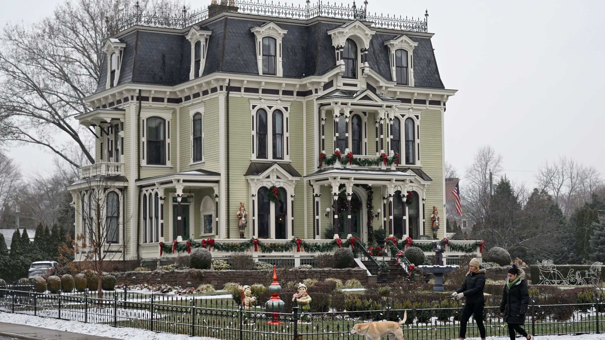 People walk by the Silas W Robbins B & B in Wethersfield, Conn., Saturday, Dec. 6, 2025, where parts of the Hallmark film "Christmas on Honeysuckle Lane" was filmed. (AP Photo/Jessica Hill)