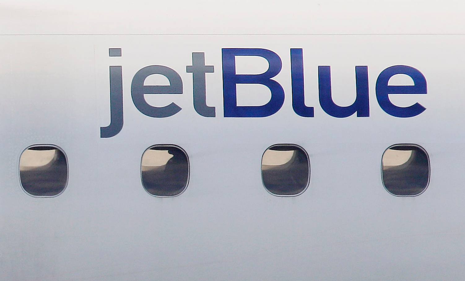 FILE - A JetBlue logo is displayed on the side of a jet as it taxis at Boston's Logan International Airport, Jan. 20, 2011. (AP Photo/Stephan Savoia, File)