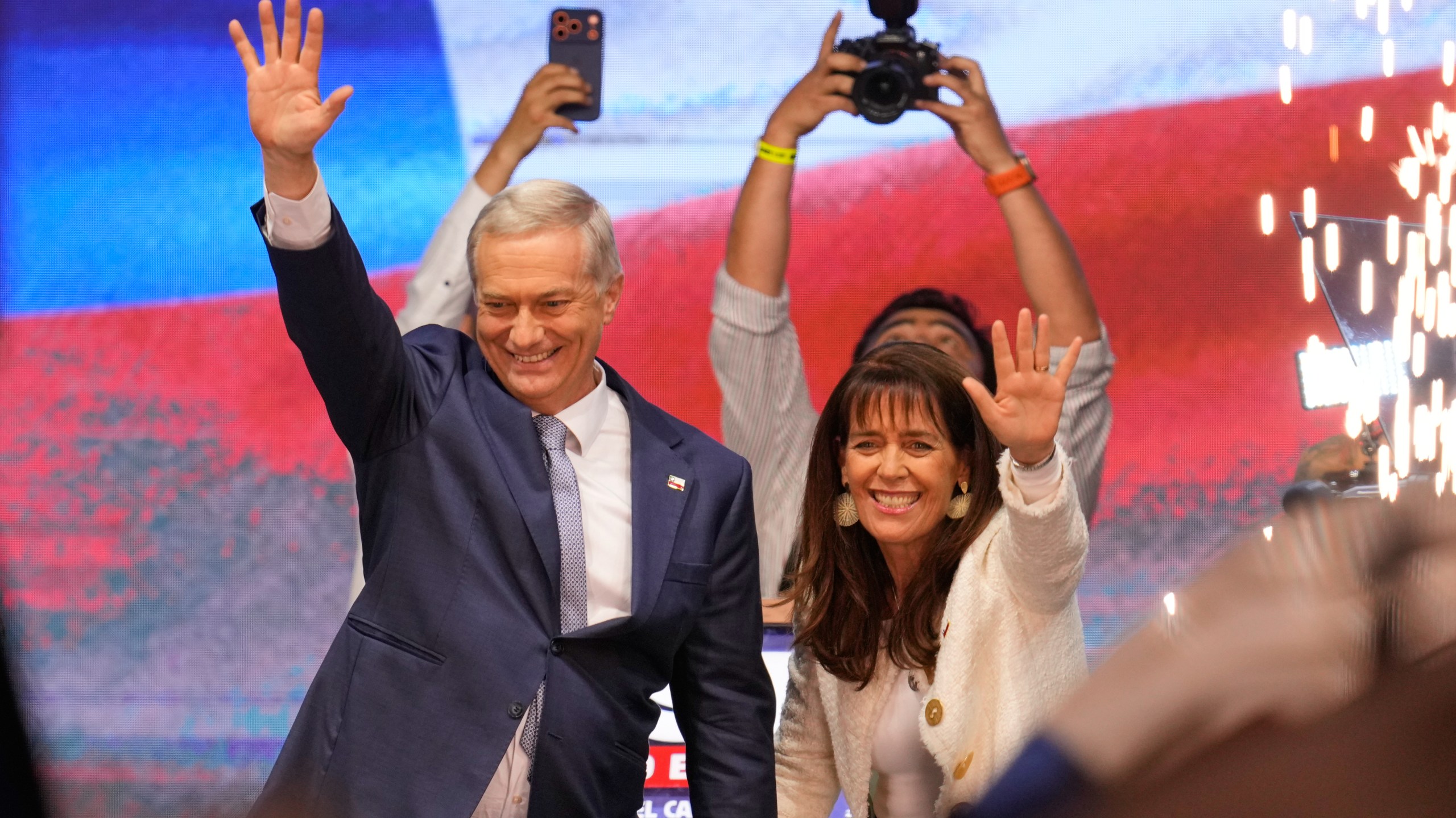 Presidential candidate Jose Antonio Kast, of the opposition Republican Party, and his wife Maria Pia Adriasola wave to supporters after winning the presidential runoff election in Santiago, Chile, Sunday, Dec. 14, 2025. (AP Photo/Matias Delacroix)
