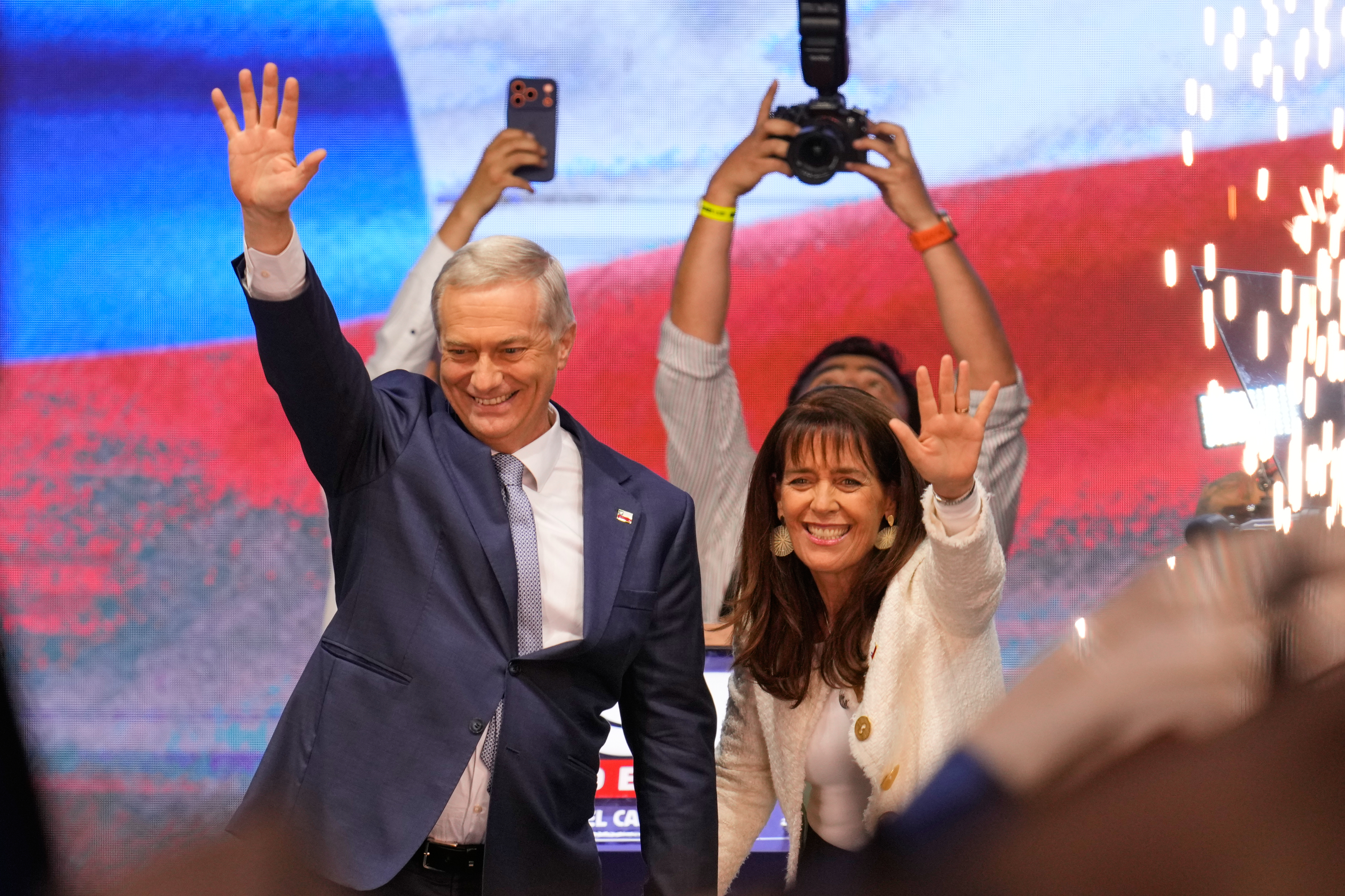 Presidential candidate Jose Antonio Kast, of the opposition Republican Party, and his wife Maria Pia Adriasola wave to supporters after winning the presidential runoff election in Santiago, Chile, Sunday, Dec. 14, 2025. (AP Photo/Matias Delacroix)