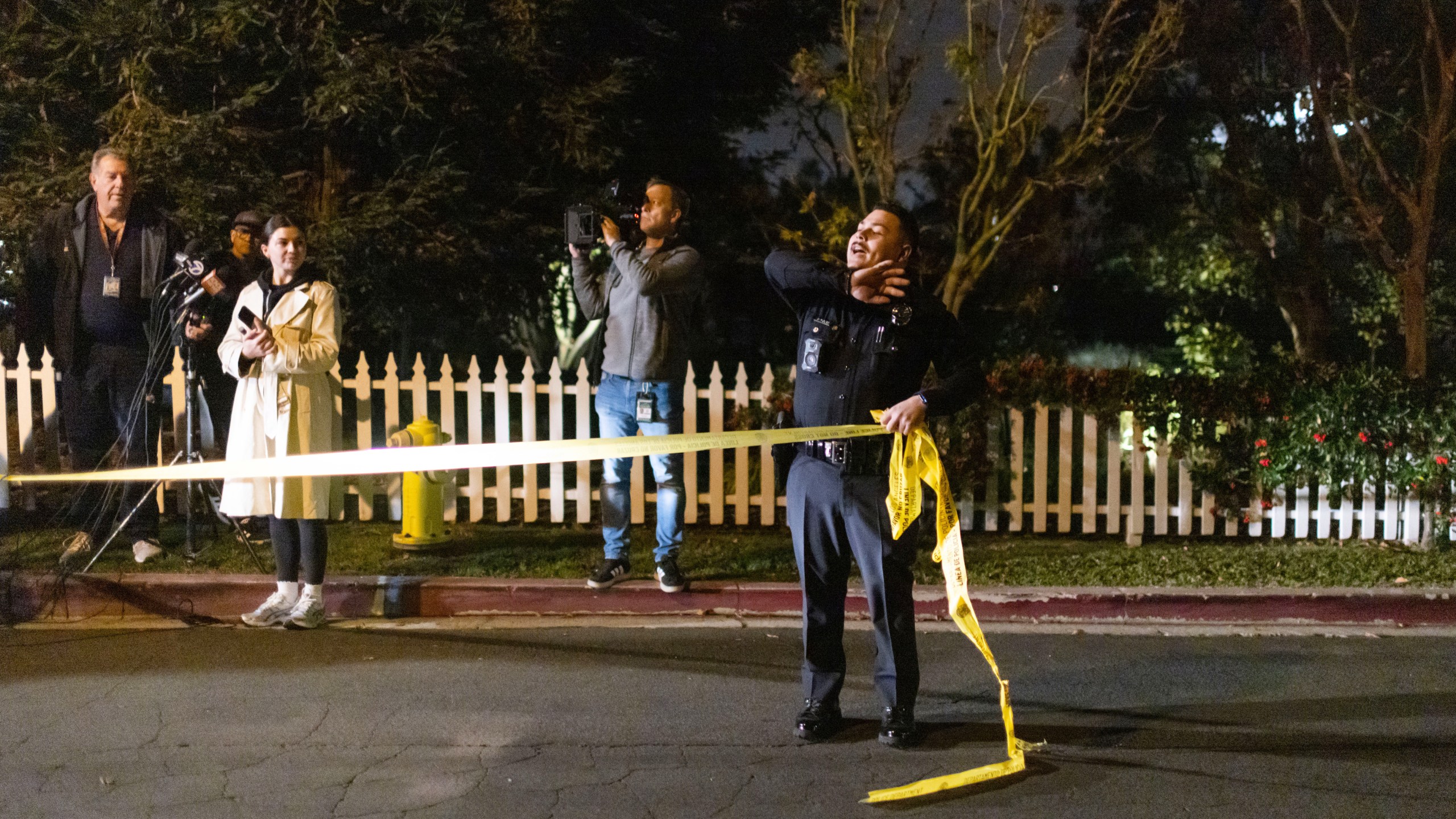 A police officer blocks off a street near Rob Reiner's residence Sunday, Dec. 14, 2025, in the Brentwood section of Los Angeles. (AP Photo/Ethan Swope)