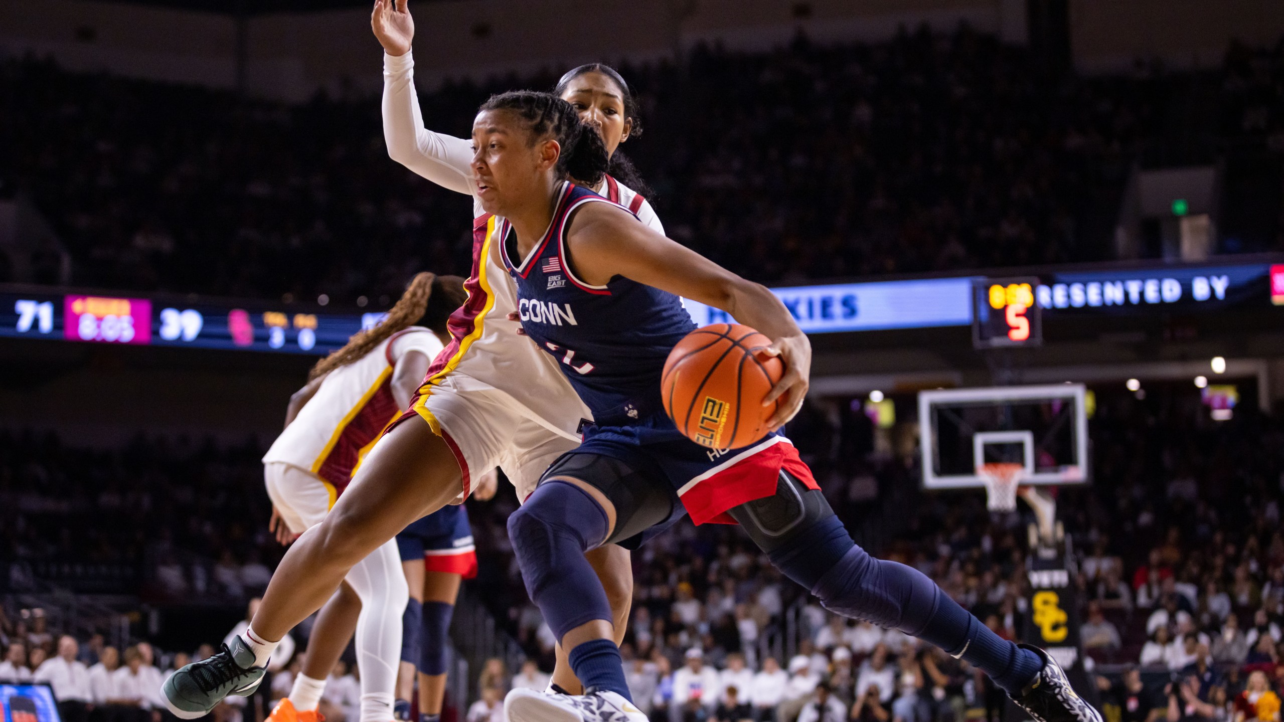 UConn guard Kk Arnold (2) drives the ball against Southern California during the second half of an NCAA college basketball game Saturday, Dec. 13, 2025, in Los Angeles. (AP Photo/Ethan Swope)