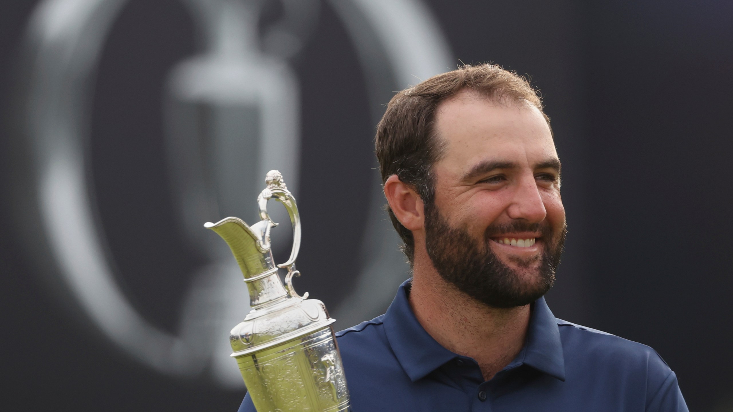 FILE - Scottie Scheffler of the United States holds the Claret Jug trophy as he poses for photographers after winning the British Open golf championship at the Royal Portrush Golf Club, Northern Ireland, July 20, 2025. (AP Photo/Peter Morrison, File)