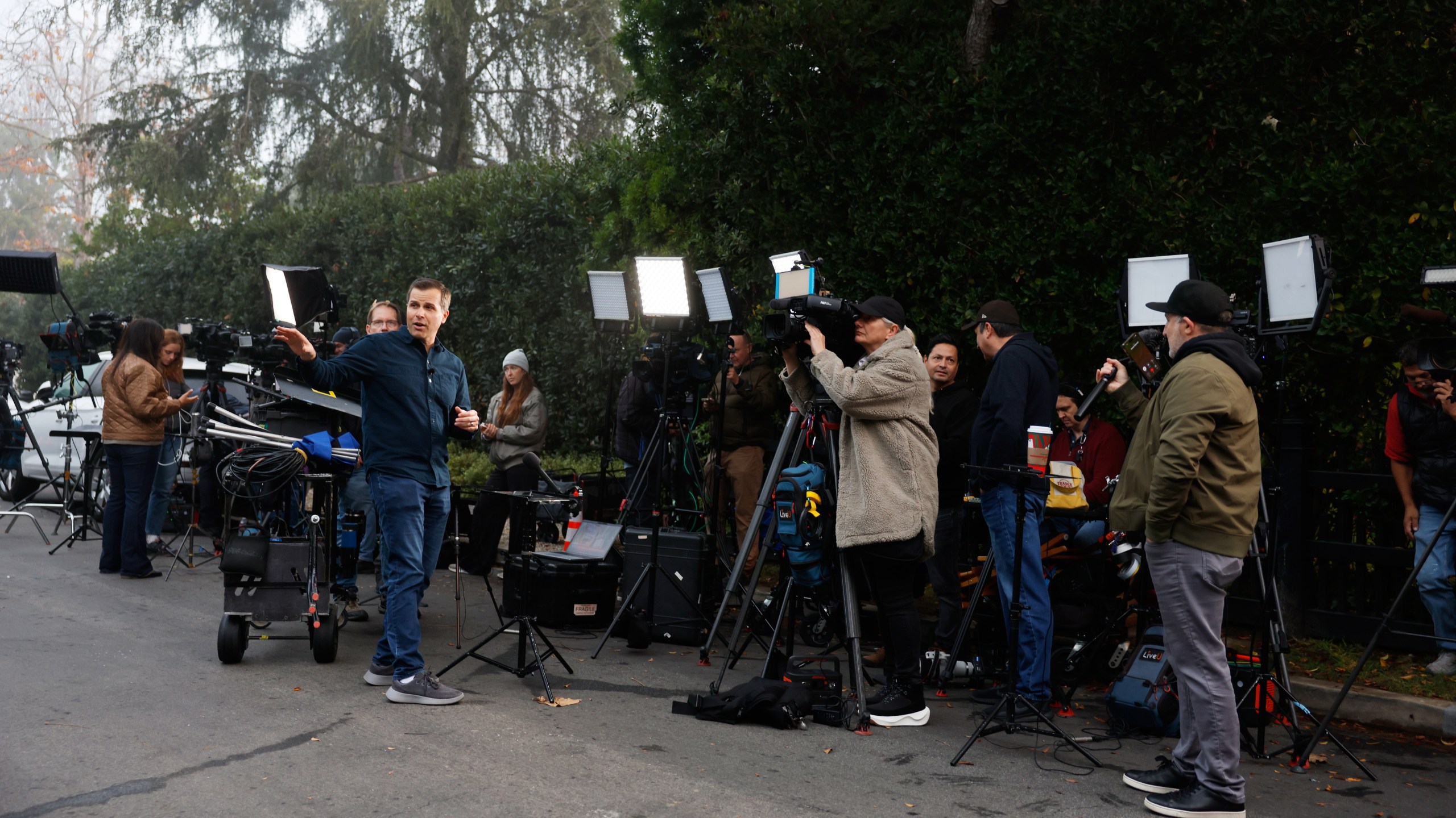 News crews stage outside Rob Reiner's residence Monday, Dec. 15, 2025, in the Brentwood section of Los Angeles. (AP Photo/Caroline Brehman)