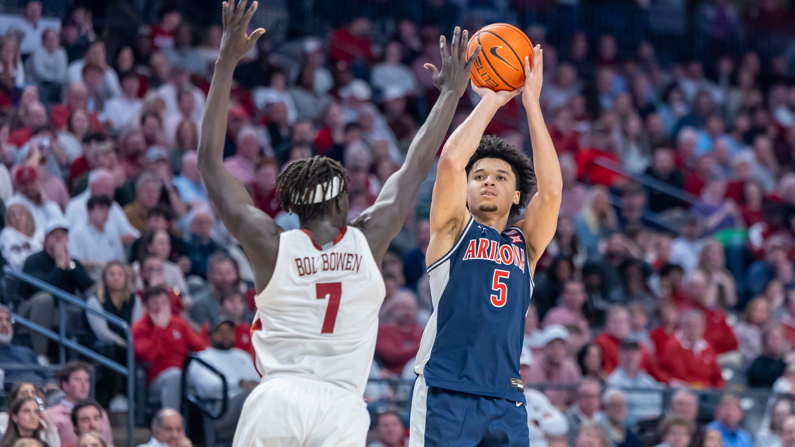 Alabama forward Amari Allen (5) shoots and hits a three-point shot over the defense of Alabama forward Taylor Bol Bowen (7) during the second half of an NCAA college basketball game, Saturday, Dec. 13, 2025, in Birmingham, Ala. (AP Photo/Vasha Hunt)