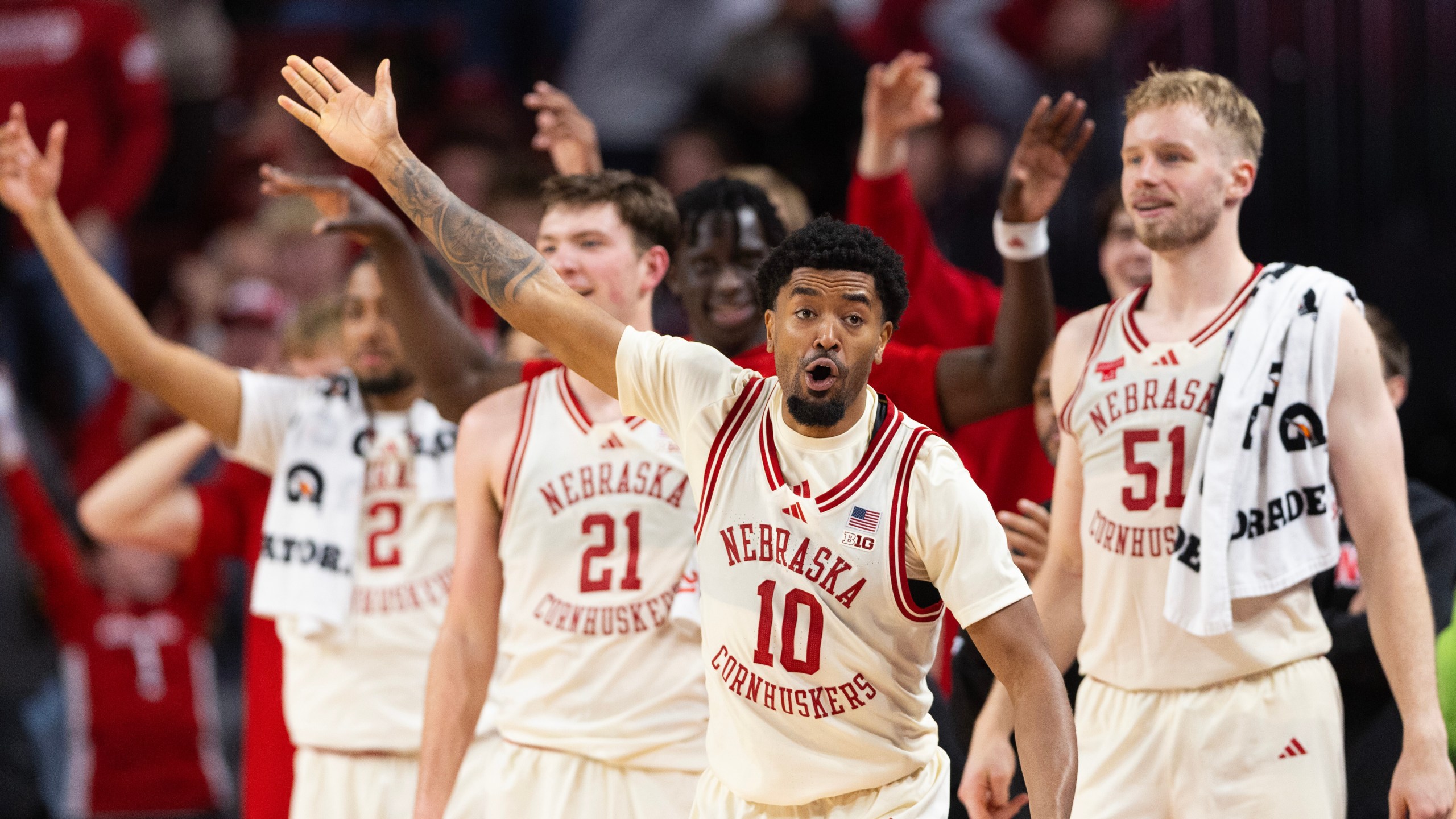 Nebraska's Jamarques Lawrence (10) and the Nebraska bench celebrate after Berke Büyüktuncel made a three-point shot during the second half of an NCAA college basketball game, Wednesday, Dec. 10, 2025, in Lincoln, Neb. (AP Photo/Rebecca S. Gratz)