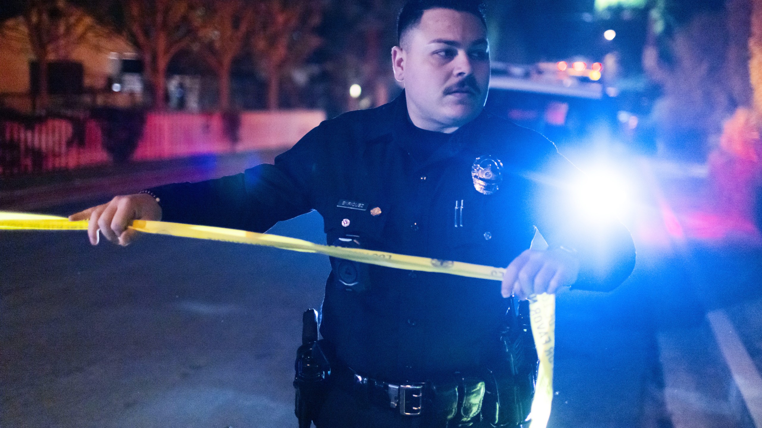 A police officer blocks off a street near Rob Reiner's residence Sunday, Dec. 14, 2025, in the Brentwood section of Los Angeles. (AP Photo/Ethan Swope)
