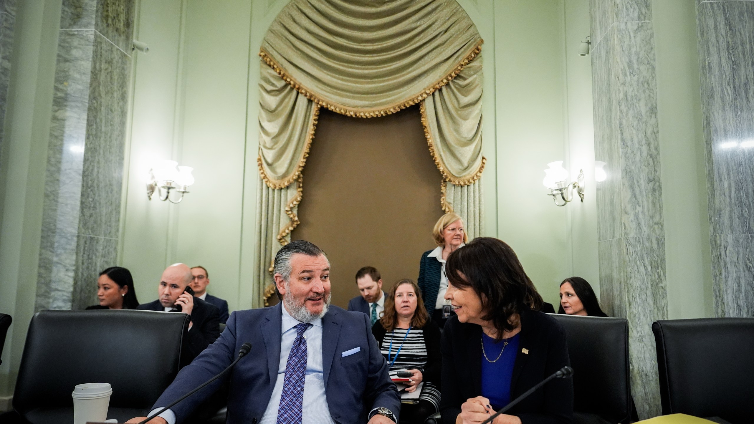 Sen. Ted Cruz, R-Texas, left, chairman of the Senate Commerce, Science and Transportation Committee, speaks with Sen. Maria Cantwell, D-Wash., right, before a hearing on the nomination of Adm. Kevin Lunday, acting commandant of the U.S. Coast Guard, for Commandant of the Coast Guard, Wednesday, Nov. 19, 2025, on Capitol Hill in Washington. (AP Photo/Julia Demaree Nikhinson)