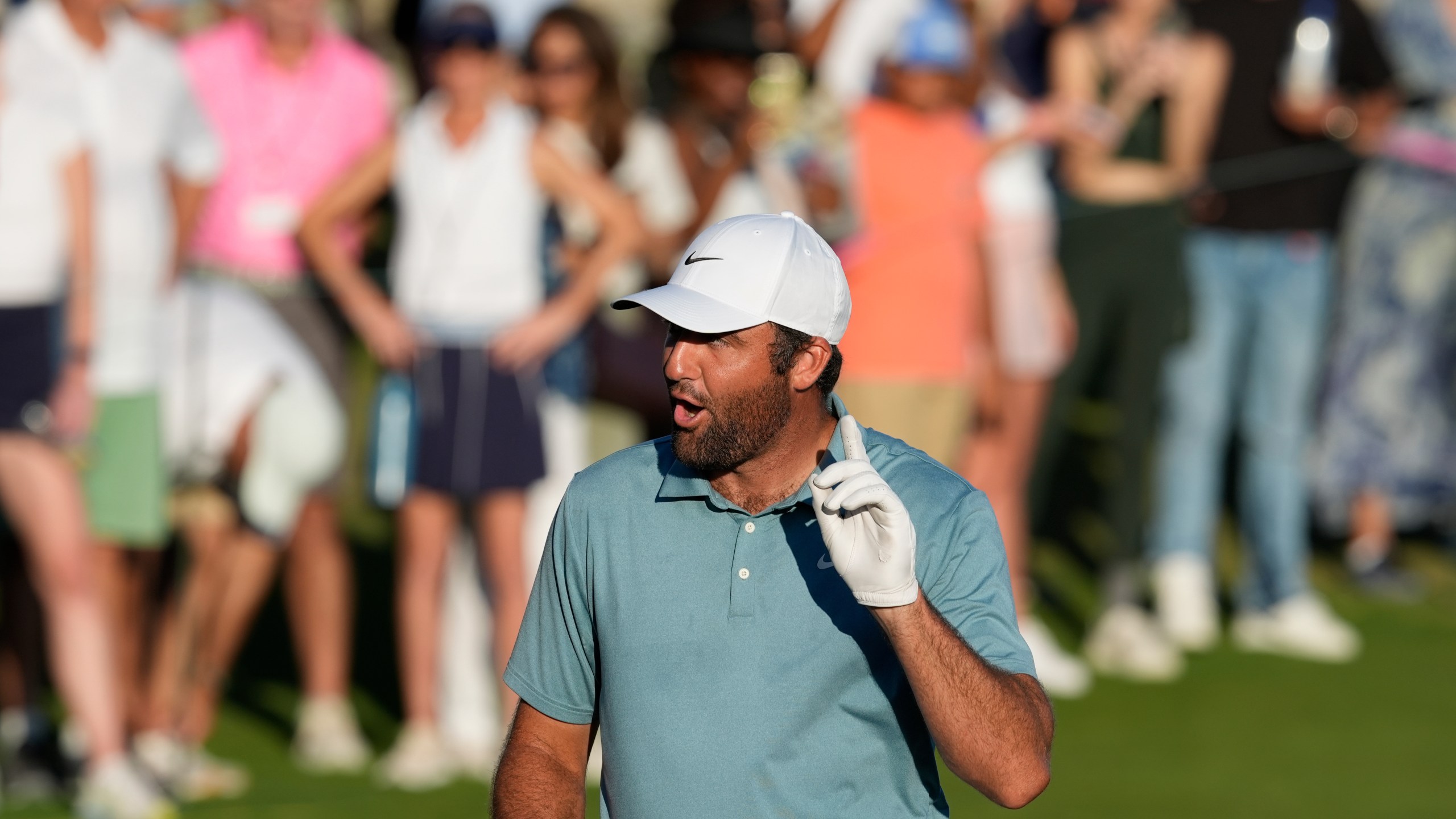 Scottie Scheffler, of the United States, reacts after his shot on 18th green during the third round of the Hero World Challenge PGA Tour at Albany Golf Club in New Providence, Bahamas, Saturday, Dec. 6, 2025. (AP Photo/Fernando Llano)