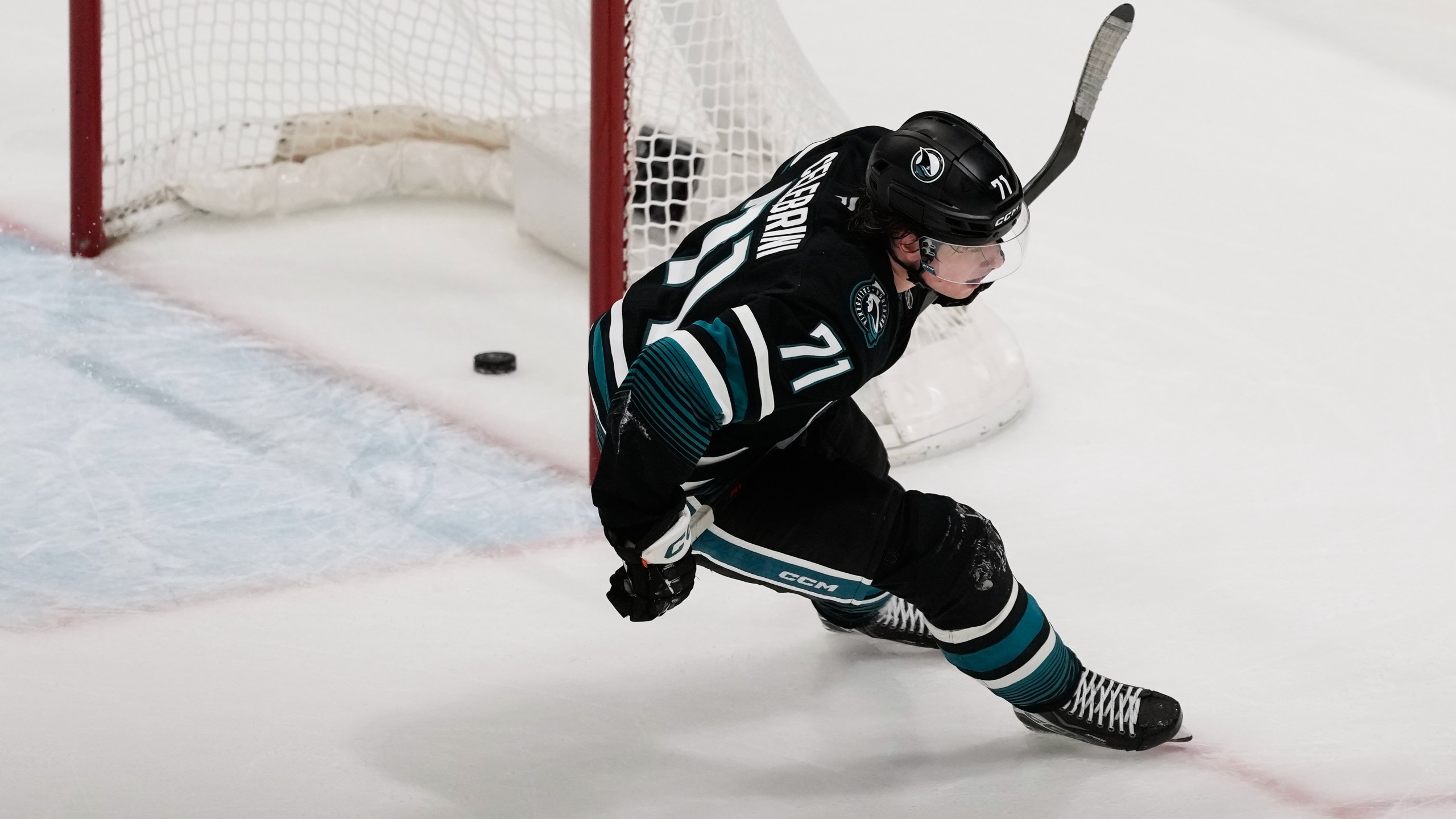San Jose Sharks center Macklin Celebrini scores an empty net goal during the third period of an NHL hockey game against the Calgary Flames in San Jose, Calif., Tuesday, Dec. 16, 2025. (AP Photo/Jeff Chiu)