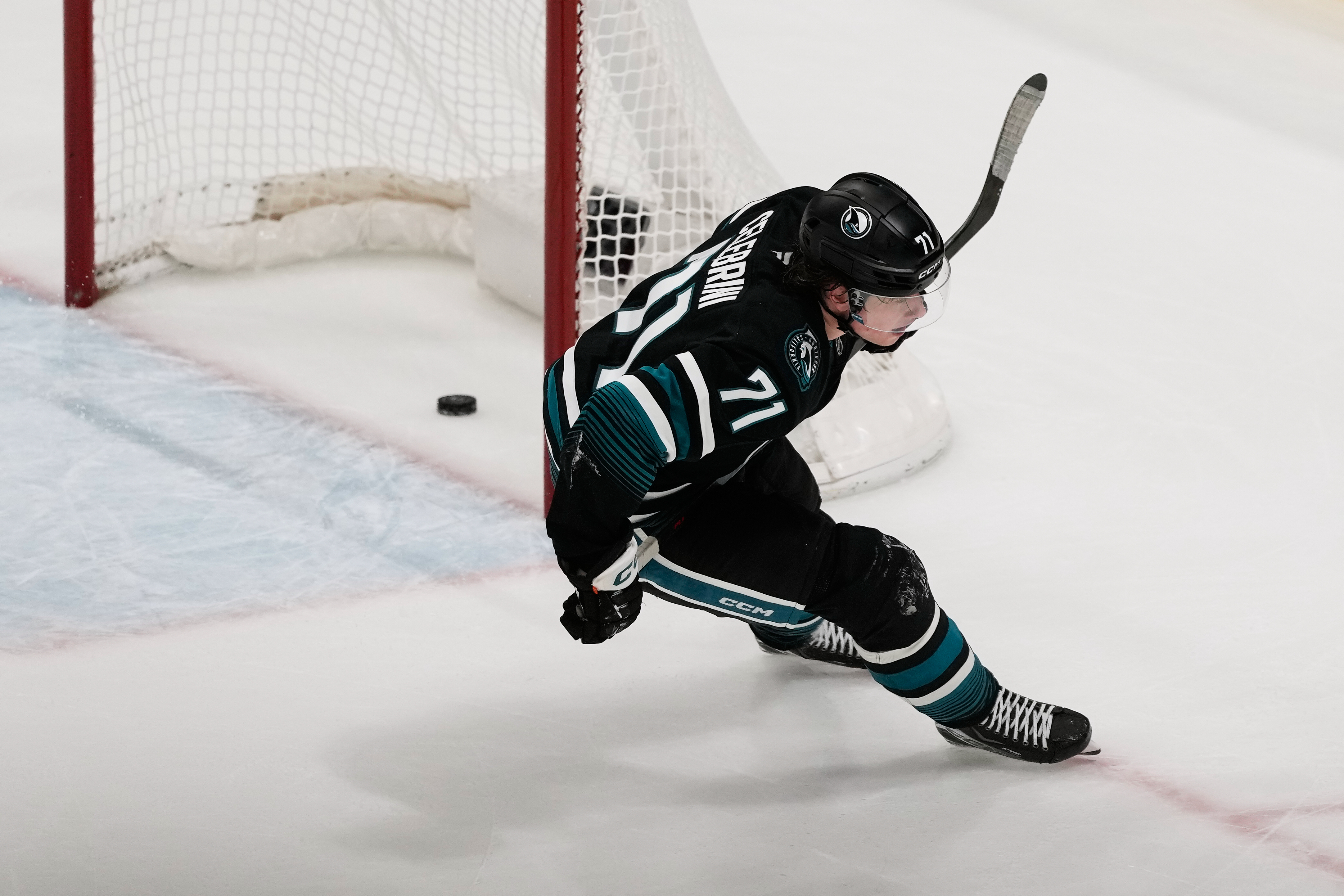 San Jose Sharks center Macklin Celebrini scores an empty net goal during the third period of an NHL hockey game against the Calgary Flames in San Jose, Calif., Tuesday, Dec. 16, 2025. (AP Photo/Jeff Chiu)