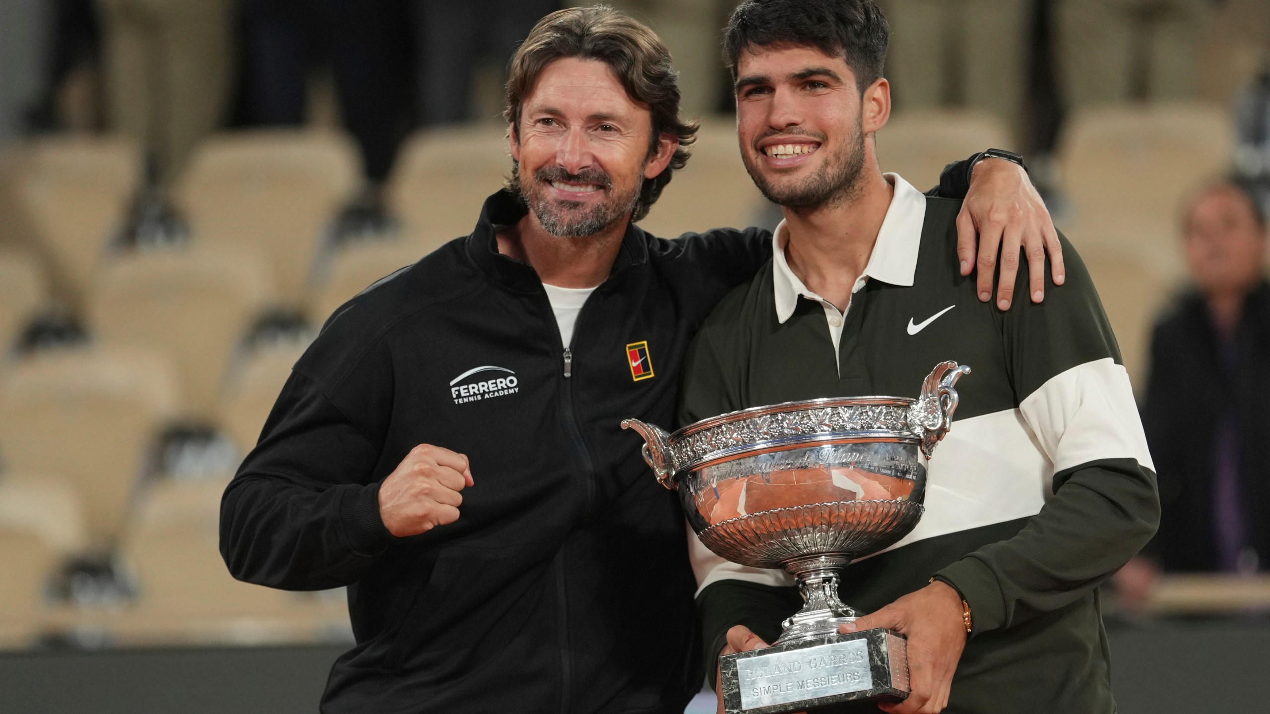 FILE - Spain's Carlos Alcaraz, right, poses with his coach Juan Carlos Ferrero after winning the final match of the French Tennis Open against Italy's Jannik Sinner at the Roland-Garros stadium in Paris, Sunday, June 8, 2025. (AP Photo/Thibault Camus, File)
