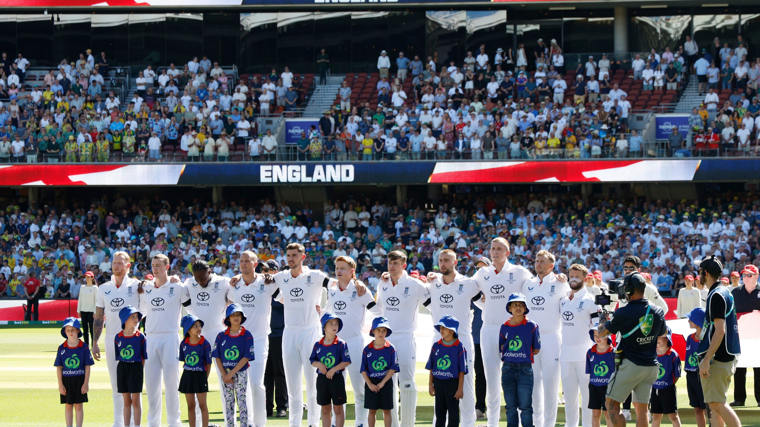 England players line up for the national anthem during play on day one of the third Ashes cricket test between England and Australia at the Adelaide Oval in Adelaide, Australia, Wednesday, Dec. 17, 2025. (AP Photo/James Elsby)