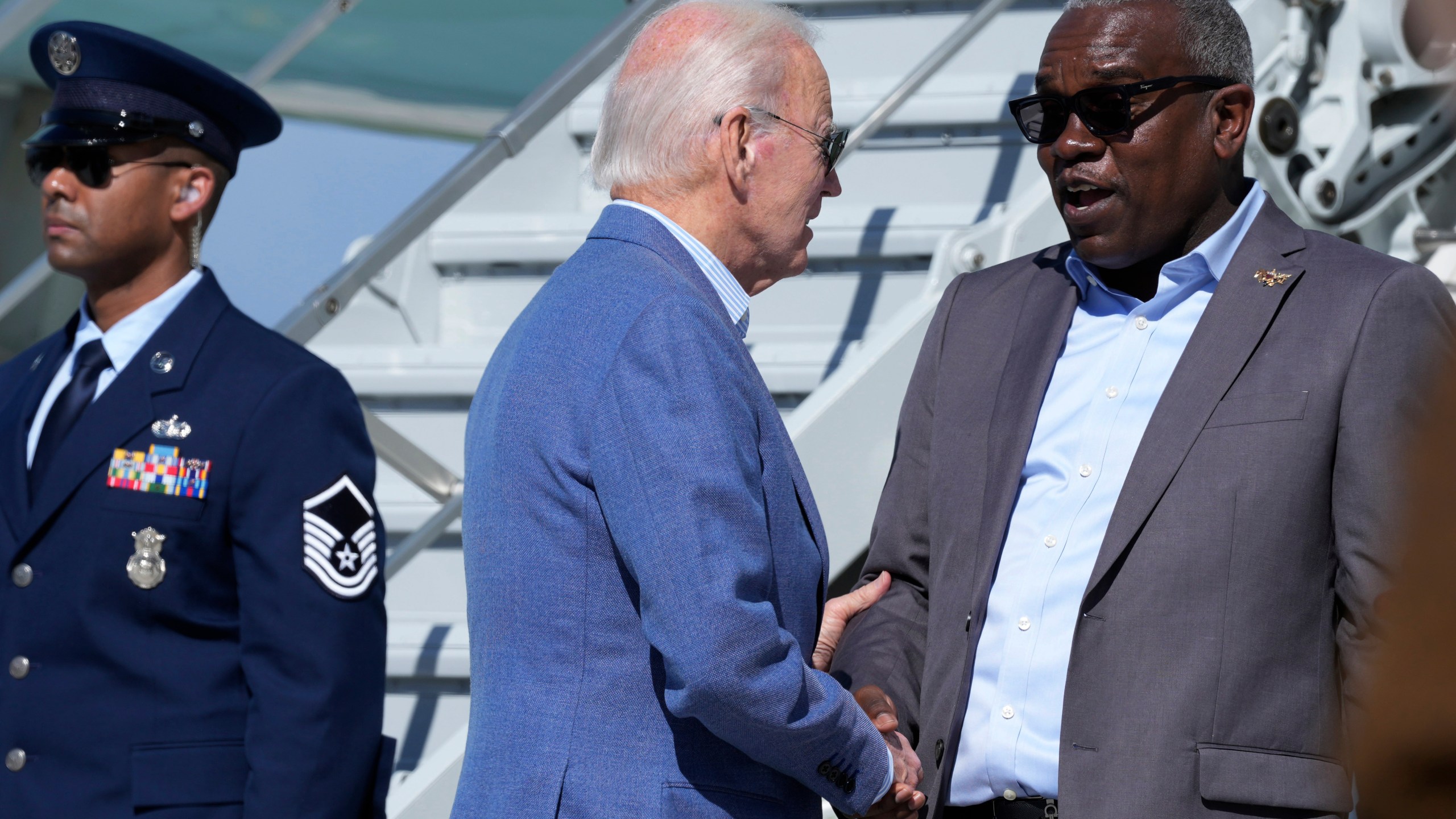 FILE - President Joe Biden, center, greets Virgin Islands Gov. Albert Bryan, Jr., right, before boarding Air Force One at Henry E. Rohlsen Airport in Christiansted, St. Croix, U.S. Virgin Islands, Dec. 31, 2024. (AP Photo/Susan Walsh, File)