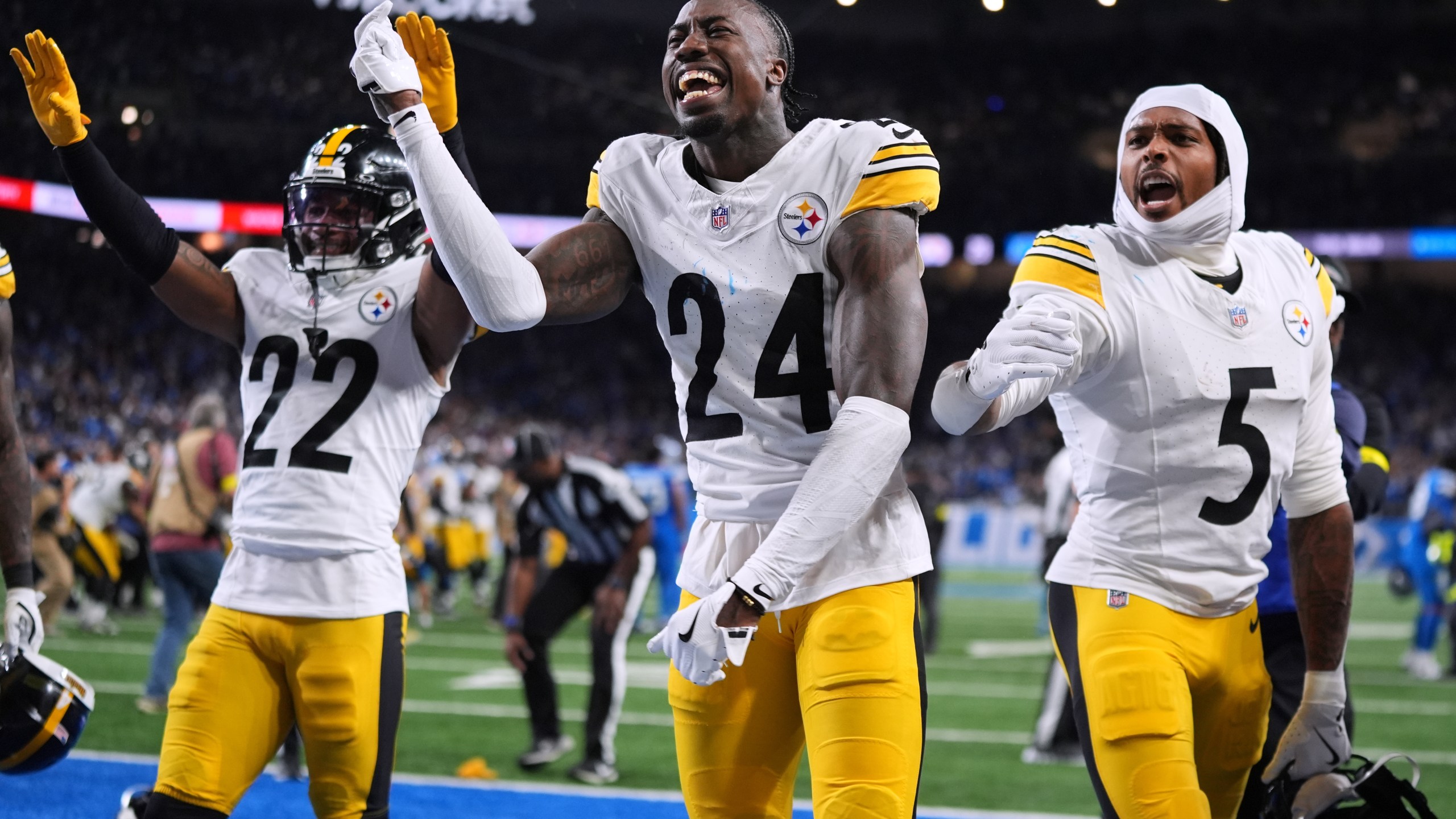 Pittsburgh Steelers' Asante Samuel Jr. (22) Joey Porter Jr. (24) and Jalen Ramsey (5) celebrate after Pittsburgh won an NFL football game against the Detroit Lions, Sunday, Dec. 21, 2025, in Detroit. (AP Photo/Ryan Sun)